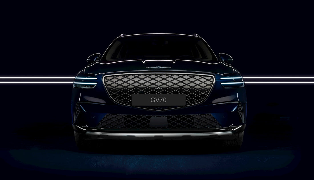 the front end of a blue car in a dark room