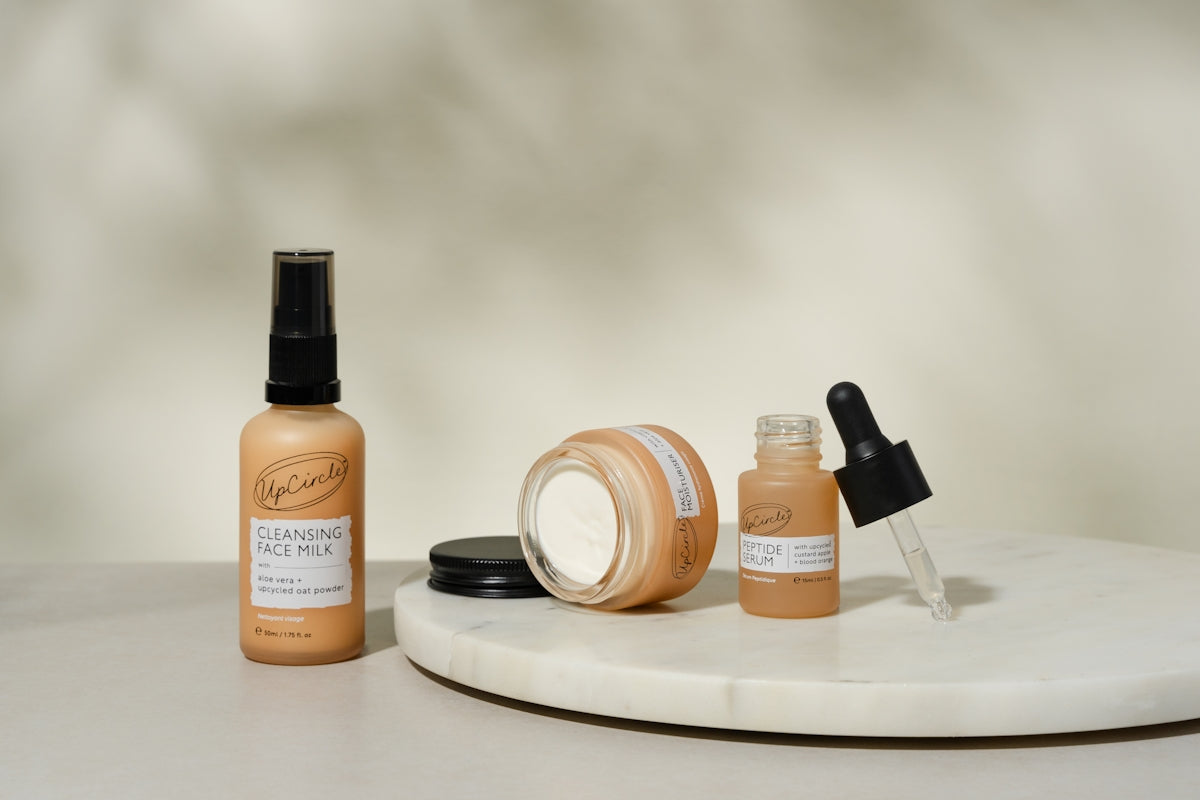 A white table topped with bottles of makeup