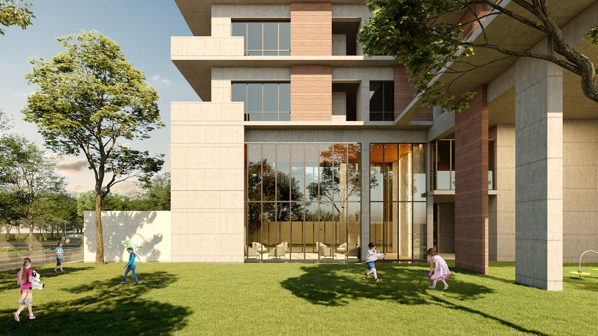 Children playing on a grassy lawn near a modern building.