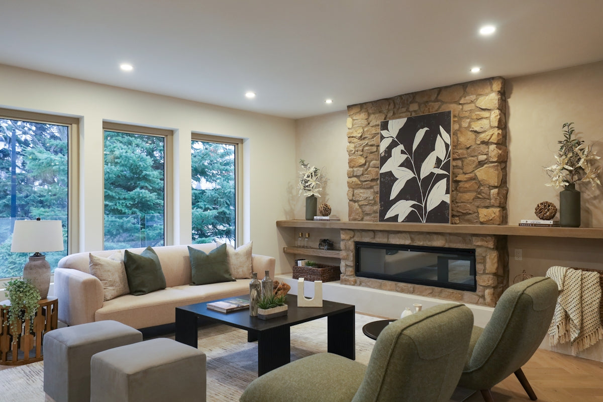 Cozy living room with stone fireplace and modern furniture.