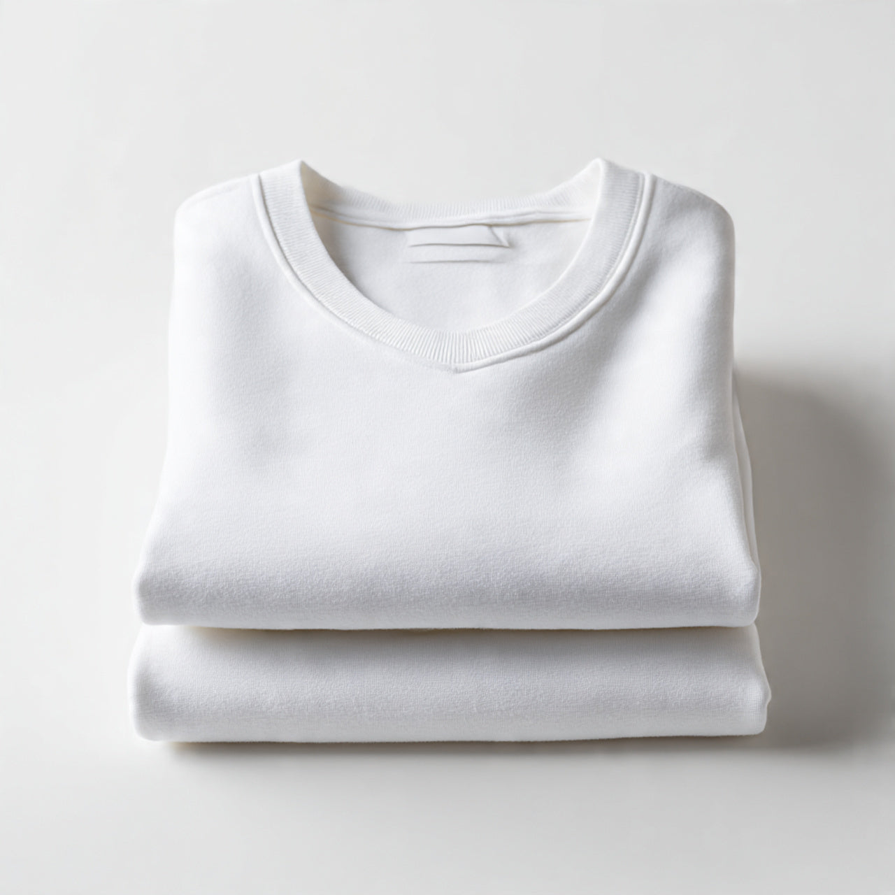 “A folded men’s lounge set (top and bottom stacked neatly) centered on a pure white seamless background. Straight-on studio shot, soft lighting, subtle shadow. No text, no logo, no model, no props.”