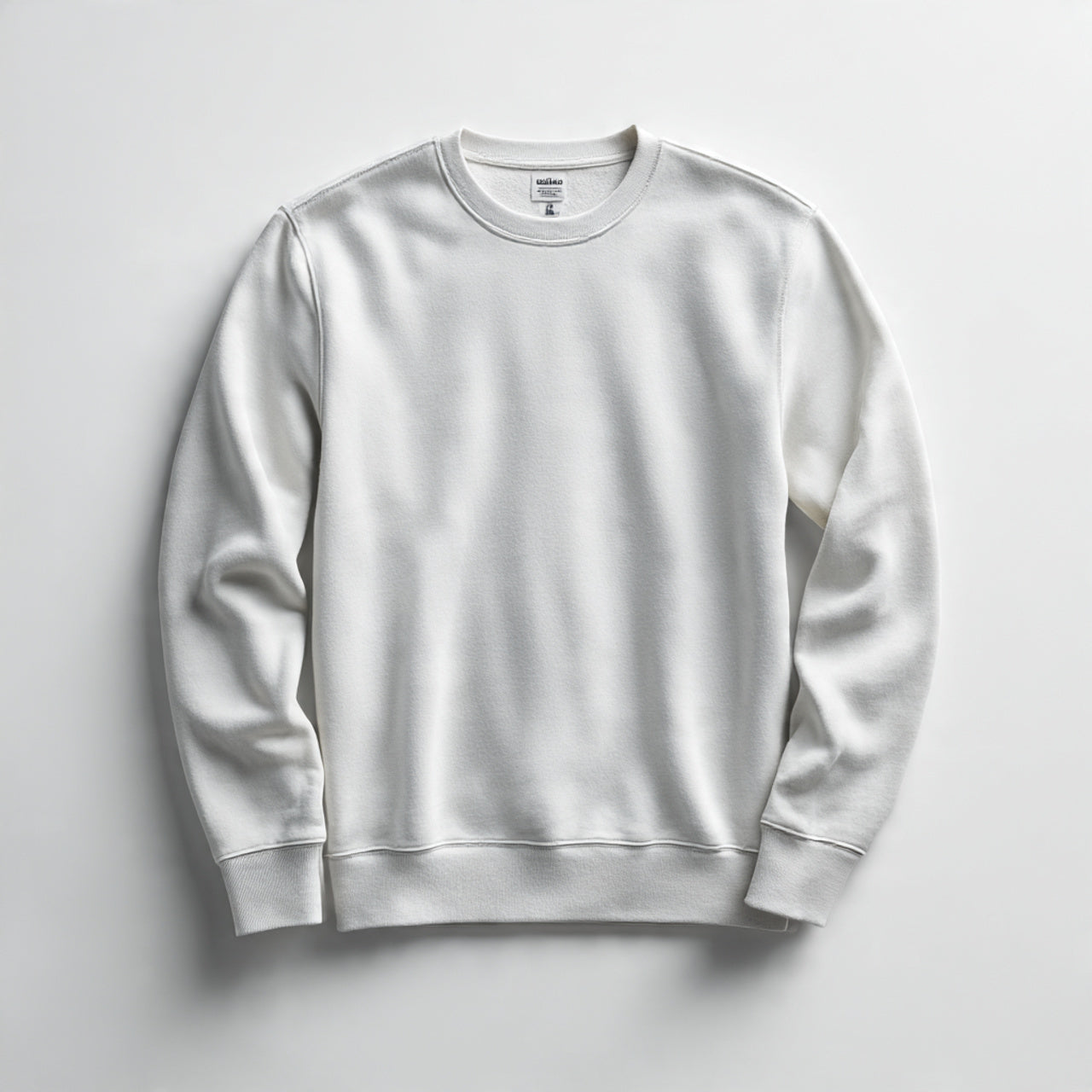 “A folded men’s sweatshirt centered on a pure white seamless background. Straight-on studio shot with soft lighting and a clean shadow. No text, no logo, no model, no props.”