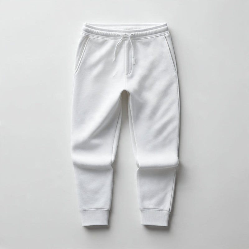 “A folded pair of men’s sweatpants centered on a pure white seamless background. Straight-on premium product shot with soft lighting and minimal shadow. No text, no logo, no model, no props.”