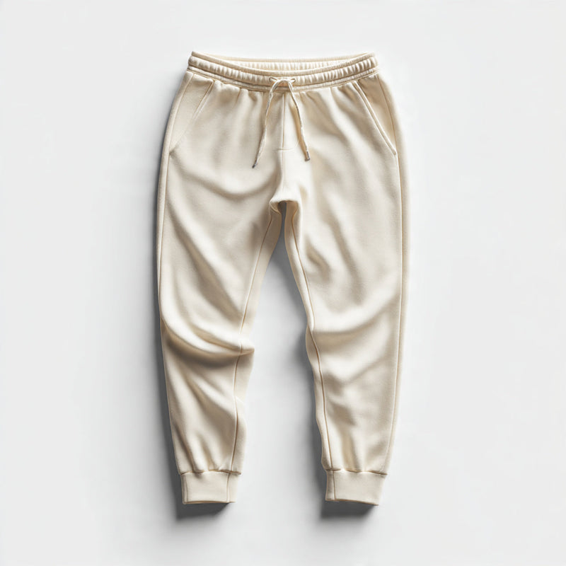 “A folded pair of women’s joggers centered on a pure white seamless background. Straight-on studio lighting with minimal shadow. No text, no logo, no model, no props.”