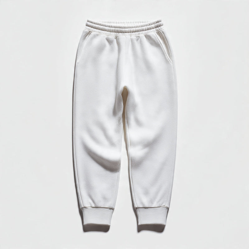 “A folded pair of women’s joggers centered on a pure white seamless background. Straight-on studio lighting with minimal shadow. No text, no logo, no model, no props.”