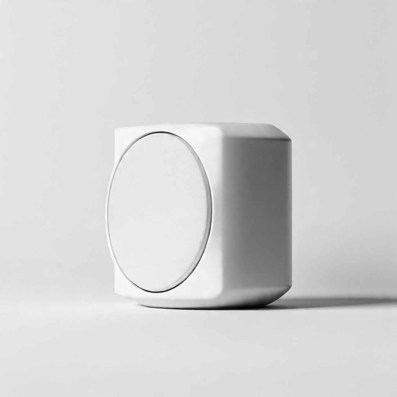 “A modern minimalist speaker centered on a pure white seamless background. Straight-on studio product shot with clean lighting and a subtle shadow. No text, no logo, no model, no props.”