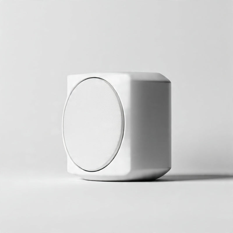 “A modern minimalist speaker centered on a pure white seamless background. Straight-on studio product shot with clean lighting and a subtle shadow. No text, no logo, no model, no props.”