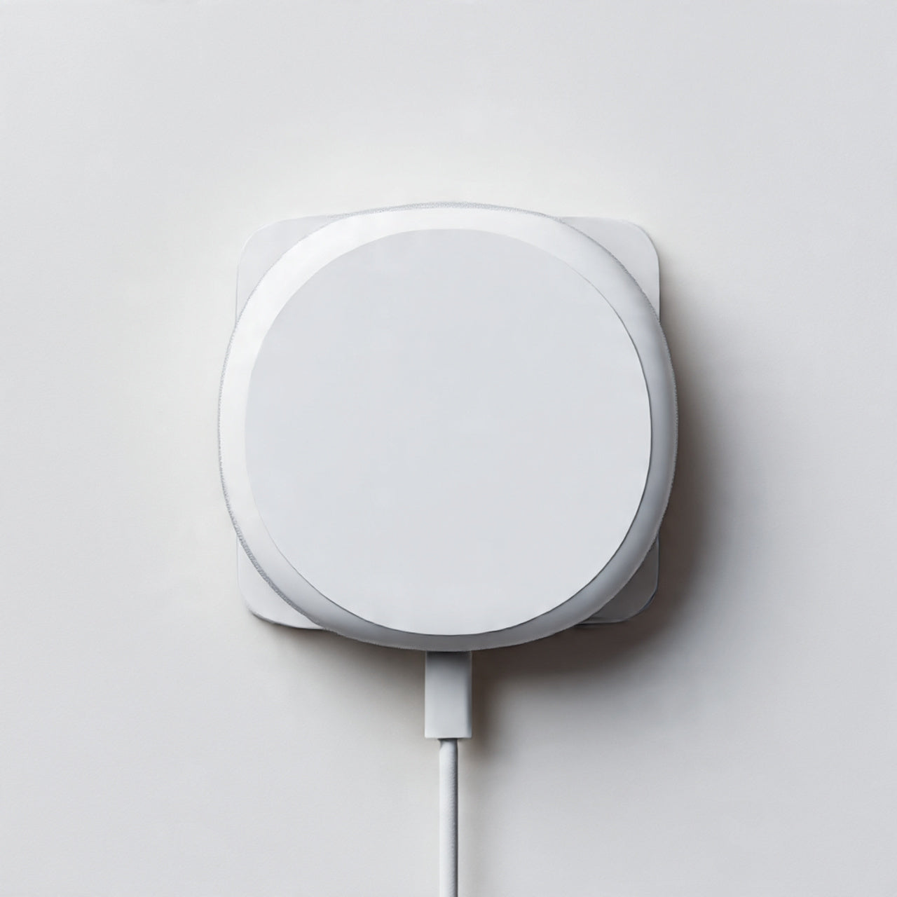 “A modern MagSafe charger or accessory centered on a pure white seamless background. Straight-on premium tech product shot with soft lighting and a clean shadow. No text, no logo, no model, no props.”