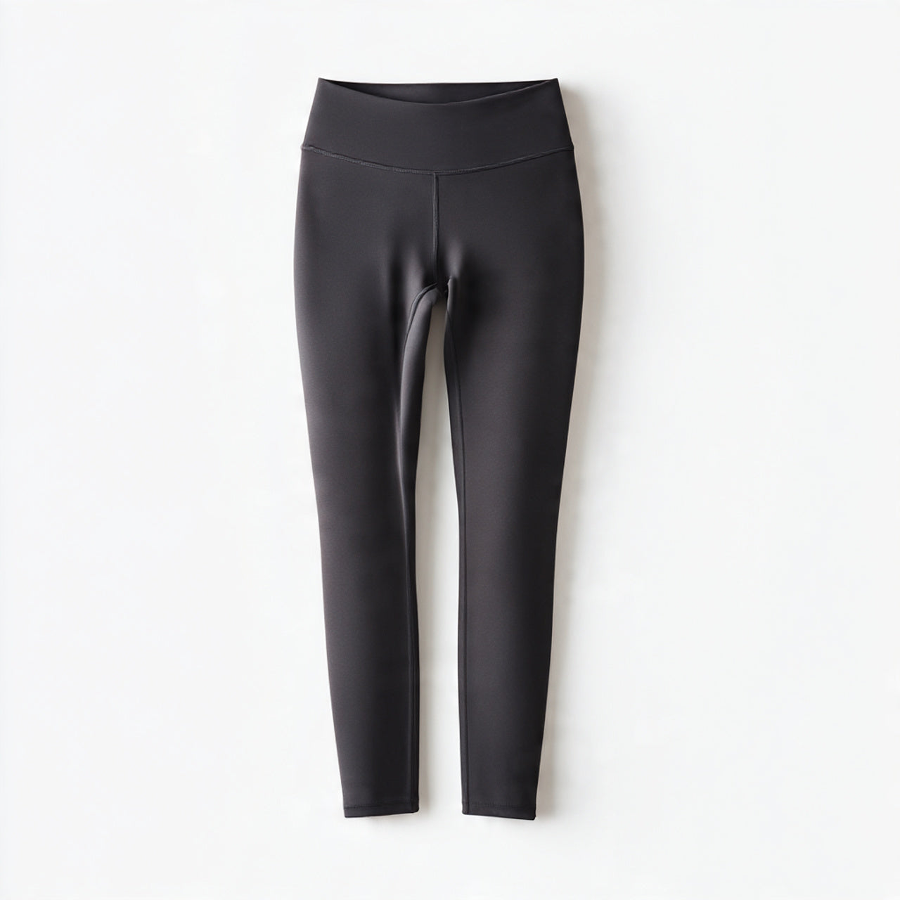“A neatly arranged pair of leggings centered on a pure white seamless background. Straight-on premium studio photography with soft lighting and a clean shadow. No text, no logo, no model, no props.”