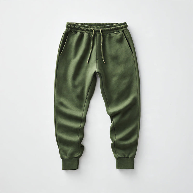 “A neatly folded pair of men’s joggers centered on a pure white seamless background. Straight-on studio lighting with a soft shadow. No text, no logo, no model, no props.”