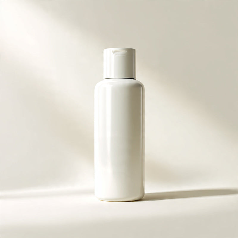 “A premium skincare bottle or jar centered on a pure white seamless background. Straight-on studio shot with soft lighting and a clean shadow. No text, no logo, no model, no props.”