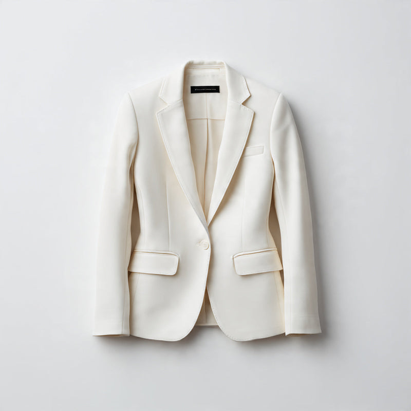 “A single women's blazer centered on a pure white seamless background. Straight-on luxury product photography with soft studio lighting and a clean natural shadow. No text, no logo, no model, no props.”