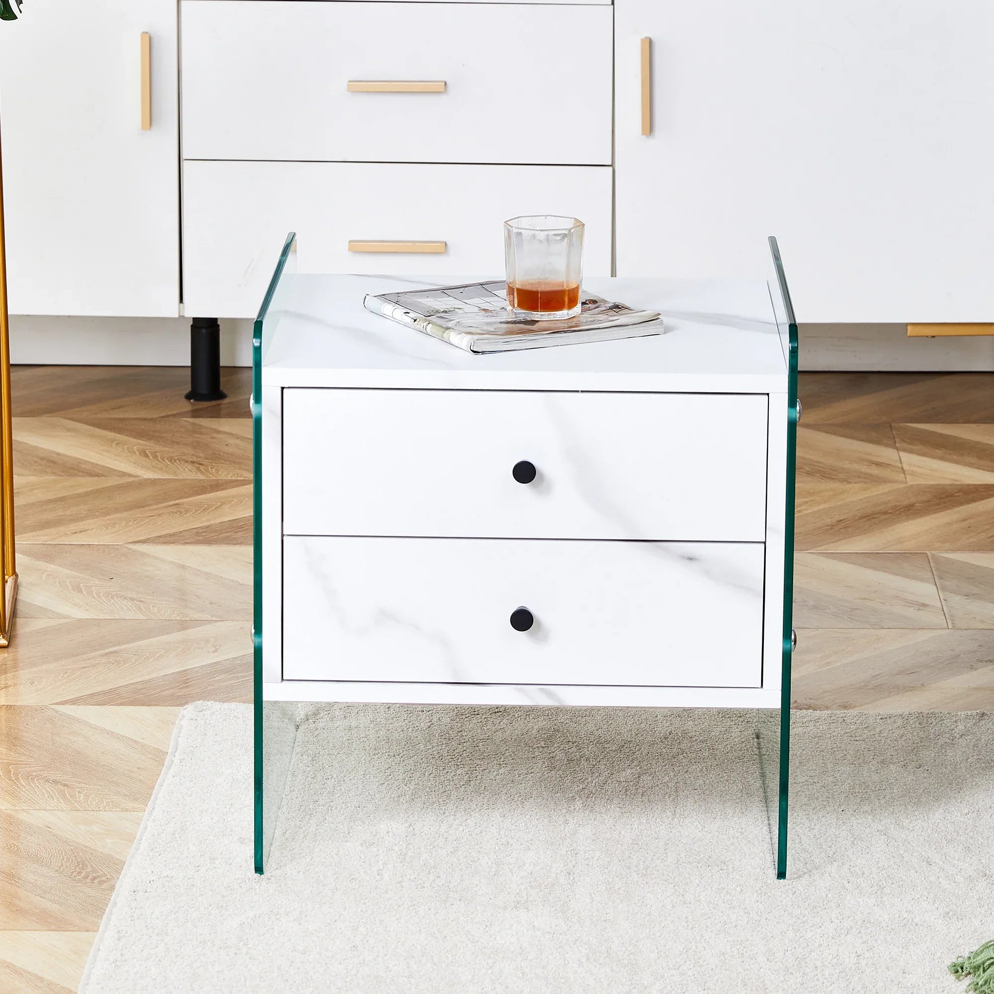 Double-drawer bedside table. The board surface is MDF sticker, and both sides are transparent tempered glass. The design is simple and elegant, with excellent storage functions. - Eloy Royal
