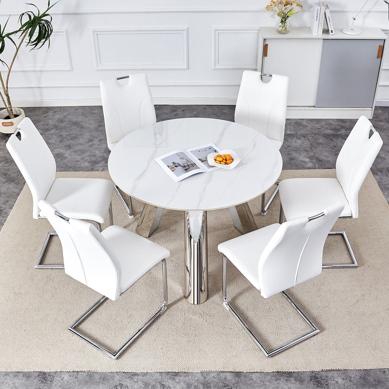 Table and chair set.A 42-inch stainless steel leg round table .Paired with 6 Uniquely designed White Dining Chairs With Silver Metal Leg.Sintered Stone Tabletop,Stainless Steels Table Legs.