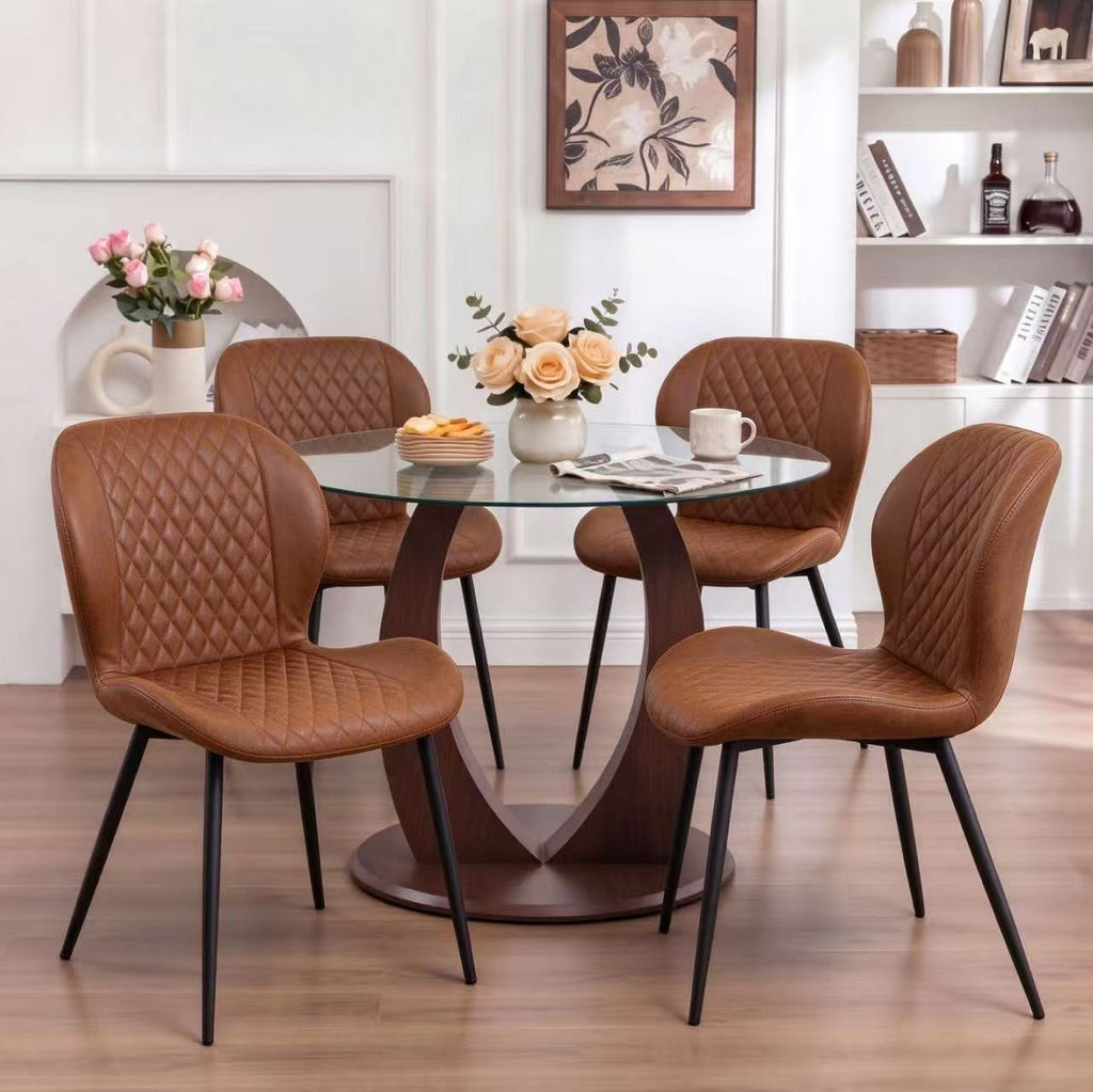 Table and chair set. A 38.6 inch glass round table, paired with four uniquely designed dining chairs with black metal legs. The table legs are made of walnut density board material.